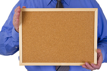 Image showing Businessman holding empty pinboard