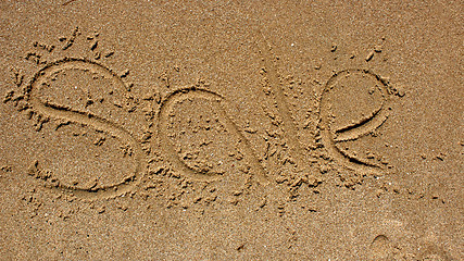 Image showing Word sale handwritten in sand