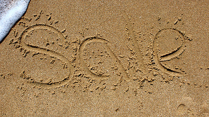 Image showing Word sale handwritten in sand