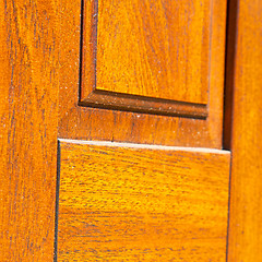 Image showing abstract texture of a brown antique wooden old door in italy   e