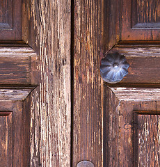 Image showing brass  knocker and wood  glass door caronno varesino varese  