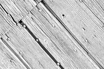 Image showing abstract texture of a brown antique wooden old door in italy   e