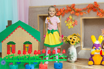 Image showing Six year old girl stands in the scenery of a country house on the matinee in kindergarten