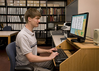 Image showing Student conducting computer research in a library archive