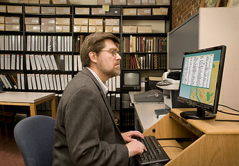 Image showing Researcher searching a computer database archive