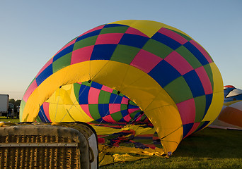 Image showing The envelope of a hot air balloon being inflated on the ground