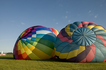 Image showing Two hot-air balloons inflating on the ground