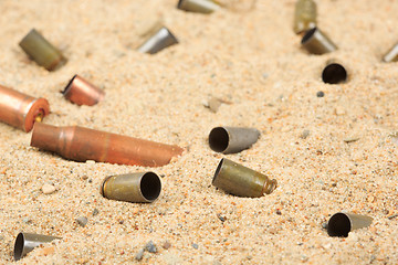 Image showing cartridge cases on the sand.