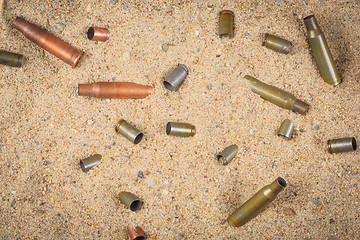 Image showing cartridge cases on the sand.