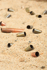 Image showing cartridge cases on the sand.