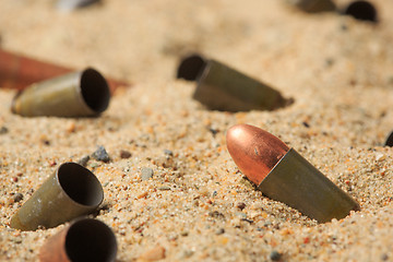 Image showing cartridge cases on the sand.