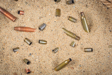 Image showing cartridge cases on the sand.