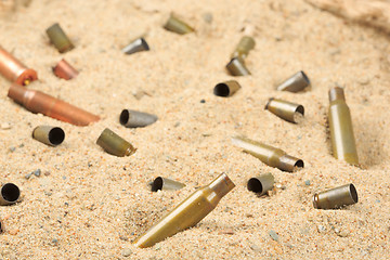 Image showing cartridge cases on the sand.