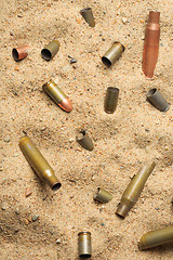 Image showing cartridge cases on the sand.