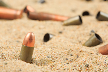 Image showing cartridge cases on the sand.