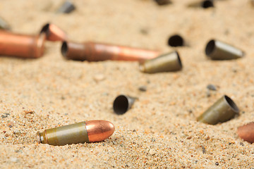 Image showing cartridge cases on the sand.