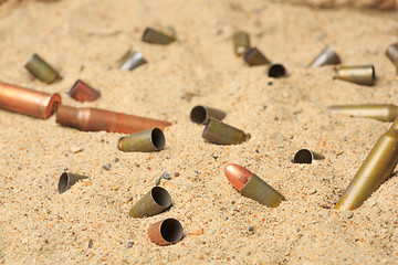 Image showing cartridge cases on the sand.