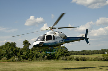 Image showing Helicopter taking off or landing in a field