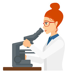 Image showing Laboratory assistant with microscope.