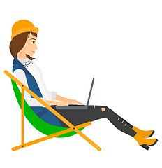 Image showing Business woman sitting in chaise lounge with laptop.