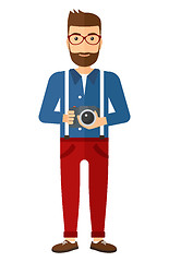 Image showing Smiling photographer holding camera.