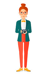 Image showing Smiling photographer holding camera.