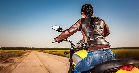 Image showing Biker girl on a motorcycle