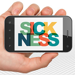 Image showing Health concept: Hand Holding Smartphone with Sickness on  display