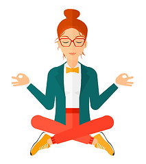 Image showing Business woman meditating in lotus pose.