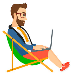 Image showing Businessman sitting in chaise lounge with laptop.