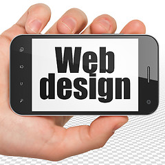 Image showing Web development concept: Hand Holding Smartphone with Web Design on display