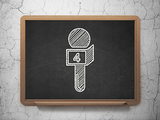 Image showing News concept: Microphone on chalkboard background