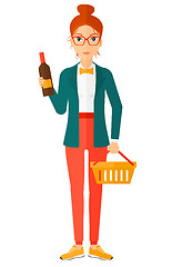 Image showing Customer with shopping basket and bottle of wine.