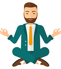 Image showing Businessman meditating in lotus pose.