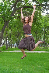 Image showing Pretty girl jumping in park