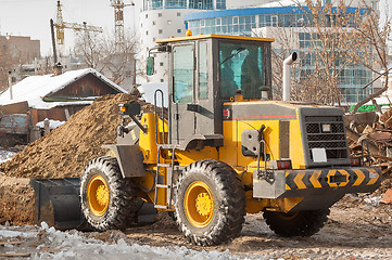 Image showing Tractor removes debris from building demolition