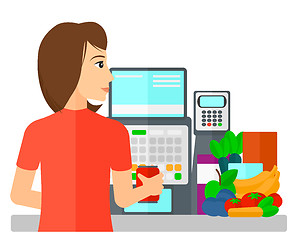 Image showing Cashier at supermarket checkout.