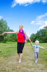 Image showing A woman with a child on the sports outing