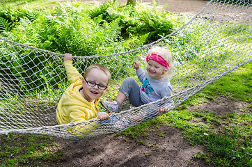 Image showing Children swinging in a hammock
