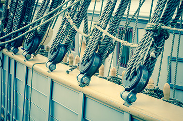 Image showing Blocks and rigging of an old sailboat, close-up, toning