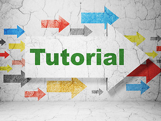 Image showing Learning concept: arrow with Tutorial on grunge wall background