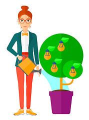 Image showing Woman watering tree with light bulbs.