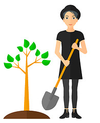 Image showing Woman plants tree.