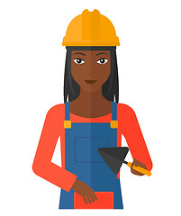 Image showing Bricklayer with spatula and brick.