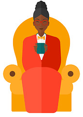 Image showing Woman sitting in chair with cup of tea.