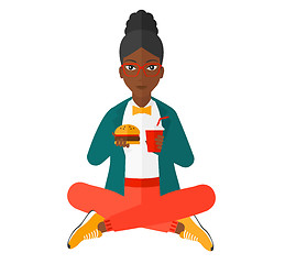 Image showing Woman eating hamburger. 