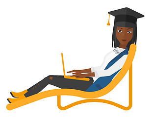 Image showing Graduate lying in chaise lounge with laptop.