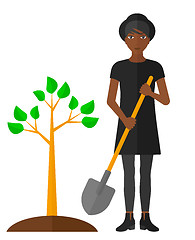 Image showing Woman plants tree.