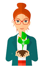 Image showing Woman holding plant.