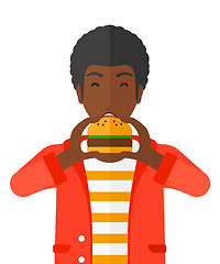 Image showing Man eating hamburger. 